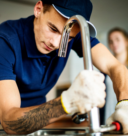 Plumber fixing kitchen sink