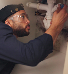 plumber-man-and-pipeline-repair-in-kitchen